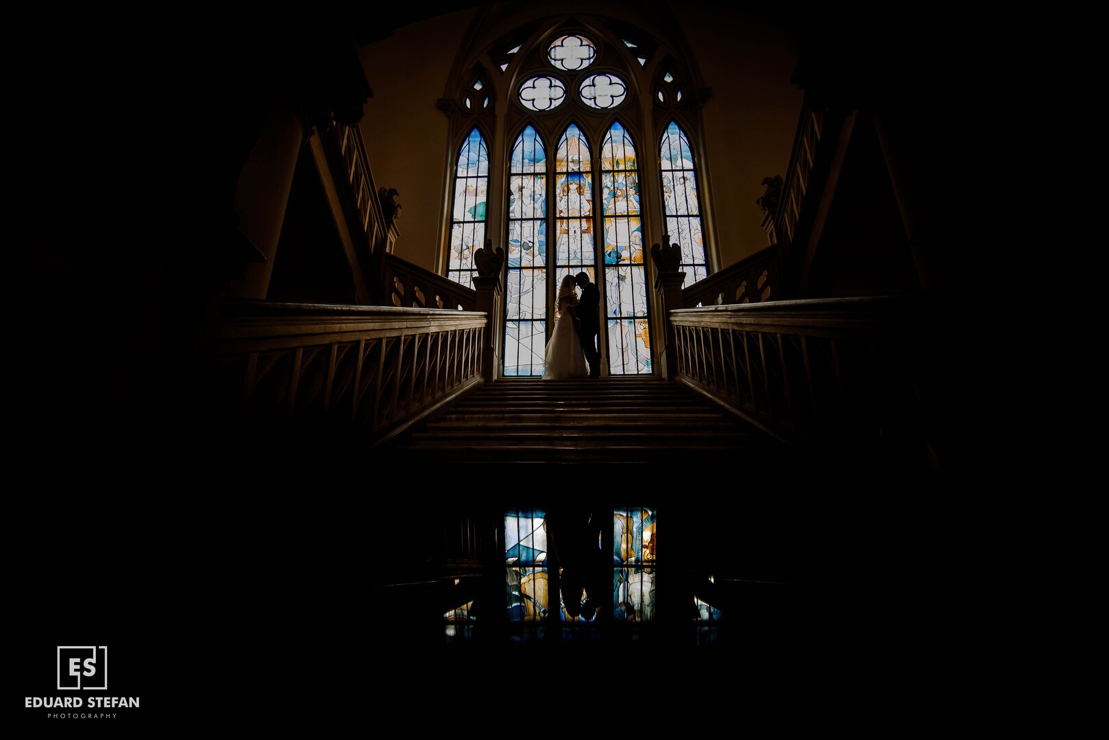 Bride and groom holding hands on a bridge